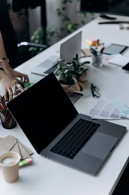 High-angle view of a stylish work desk featuring dual monitors, keyboard, mouse, and modern accessories.